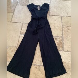 Anthropologie Elegant Black Jumpsuit- tie waist-zip back
Pit to pit 13”
Inseam19